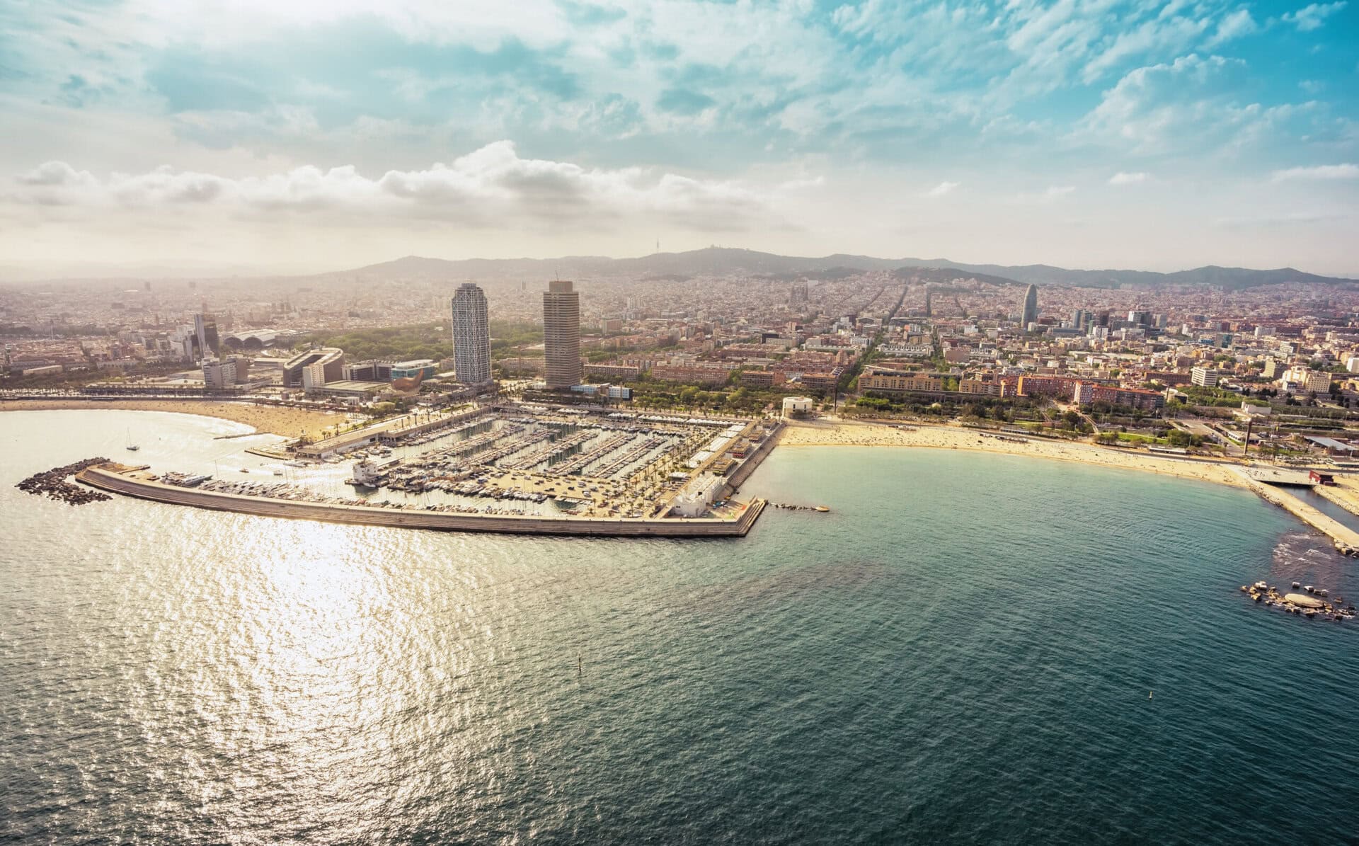 sonne-palmen-skyline-view-skyscrapers-beach-spain-gay-hotel-barcelona-spanien-urlaub-lgbtqia-reise-strand-stadt-meer